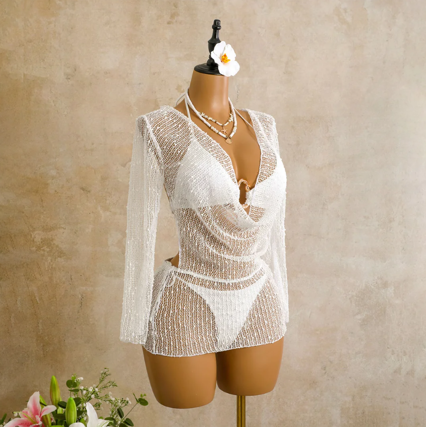 Angled front view of the ivory Milano Set cover-up on mannequin, showing the sheer open-knit texture, long sleeves and draped cowl front.