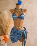 Azure blue textured triangle bikini and matching wrap sarong set displayed on mannequin with coastal resort styling.
