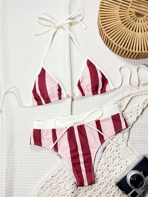 Pink and burgundy striped triangle bikini set with white binding, bead centre detail and tie-front bottoms in a flat lay.