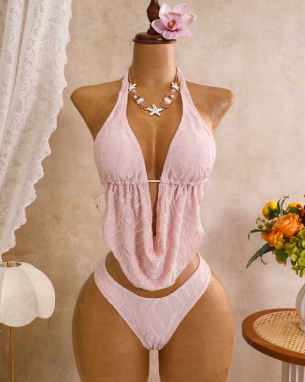 Blush textured halter bikini set displayed on mannequin with draped scarf-style top and high-leg bikini bottoms.