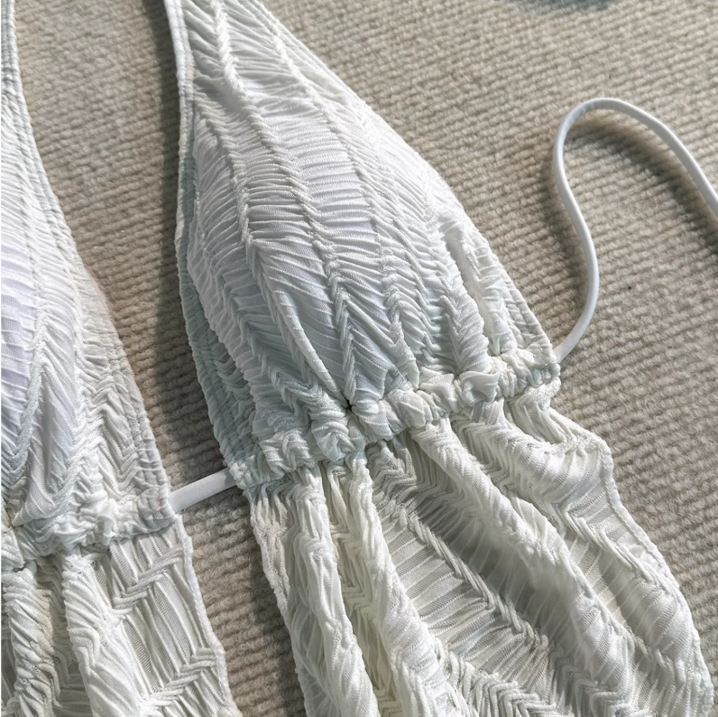 Close-up of white textured Barbados halter bikini top with ruched cups and draped front detail.