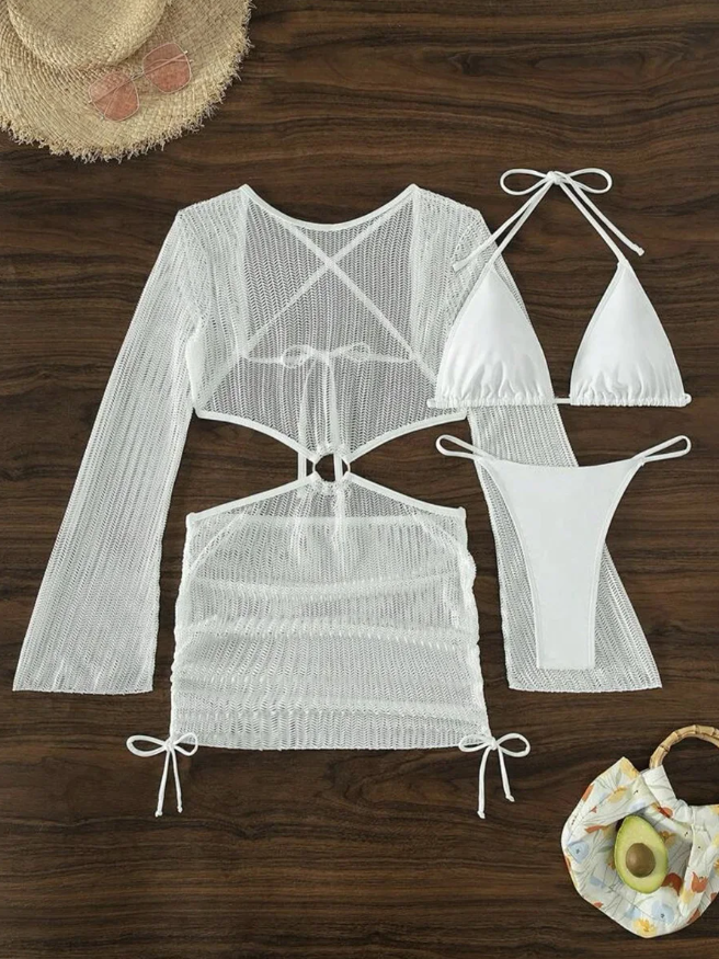 Flat lay view of white three-piece swim set with a triangle halter bikini, minimal bikini bottoms and a sheer long-sleeve knit mini dress.
