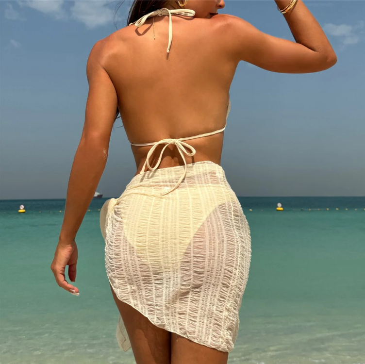 Back view of ivory textured bikini and matching sheer sarong with halter neck tie and back tie fastening.