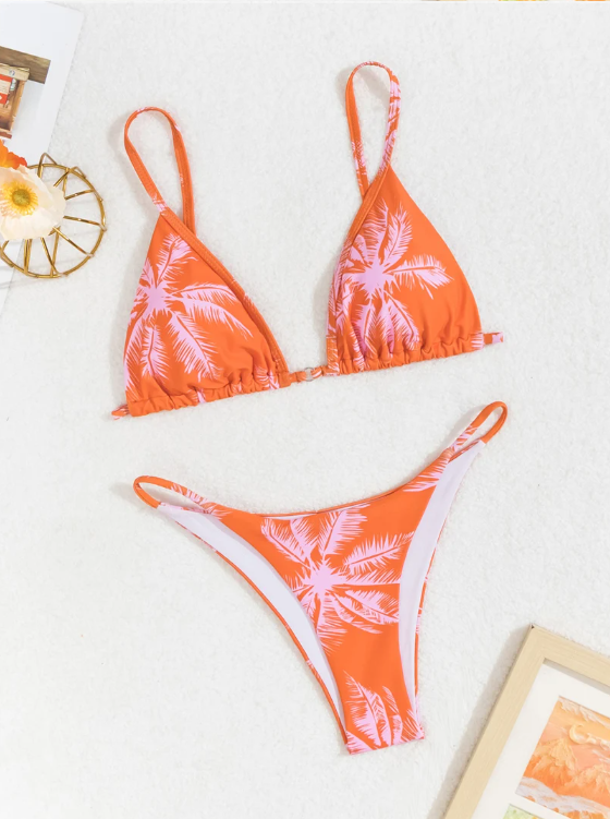 Orange palm print bikini set flat lay with triangle top and high-leg bottoms.
