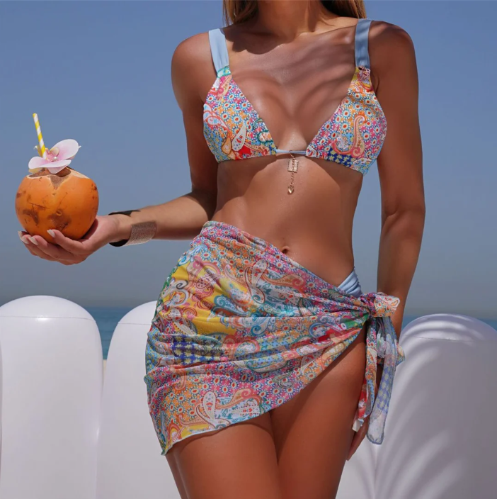 Catalina paisley bikini and matching sarong set worn by model with blue contrast straps and side-tie wrap skirt.