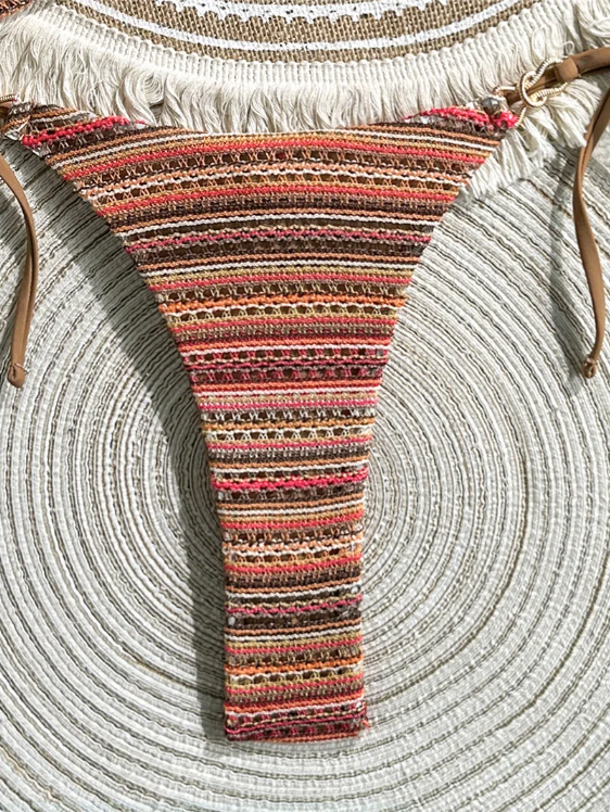 Close-up of brown striped tie-side bikini bottoms with textured crochet-look fabric.