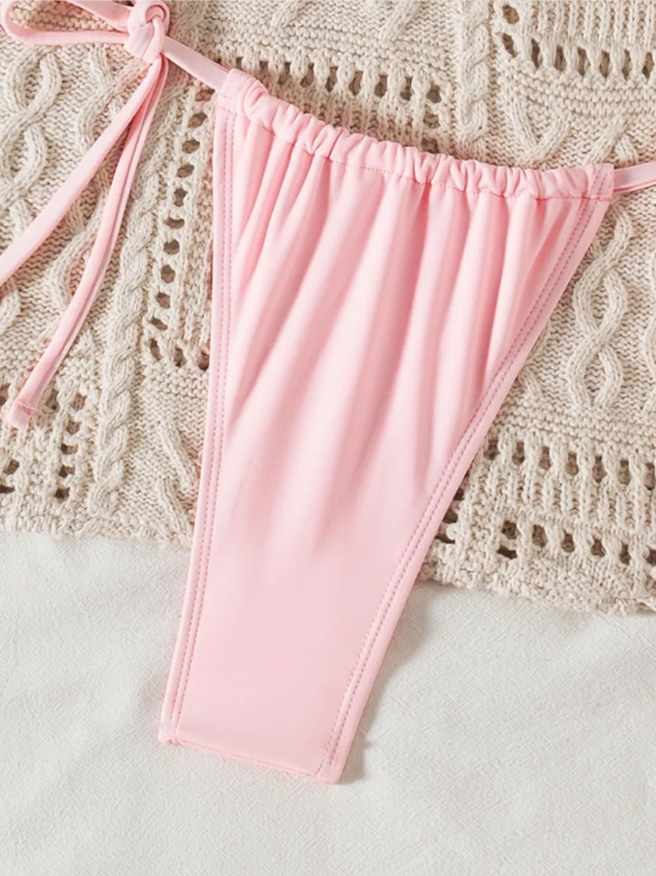 Close-up of Coral Bay pink bikini bottoms with gathered front, slim side ties and smooth stretch swim fabric.