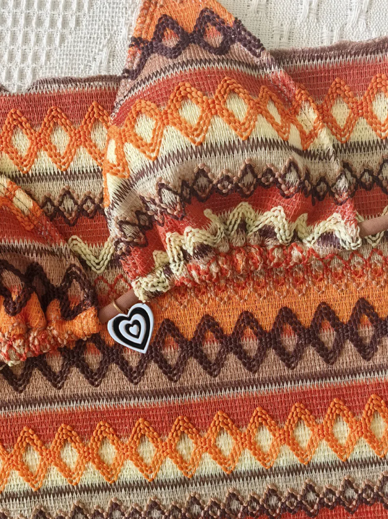 Close-up of the Curaçao Bikini Set fabric showing the intricate zigzag stripe pattern and heart charm detail.