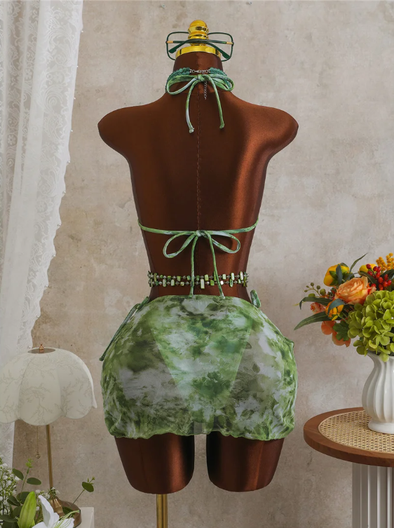 Back view of CURATOR Collection Capri Set with green marbled bikini, tie-back halter top and matching sheer mini sarong.