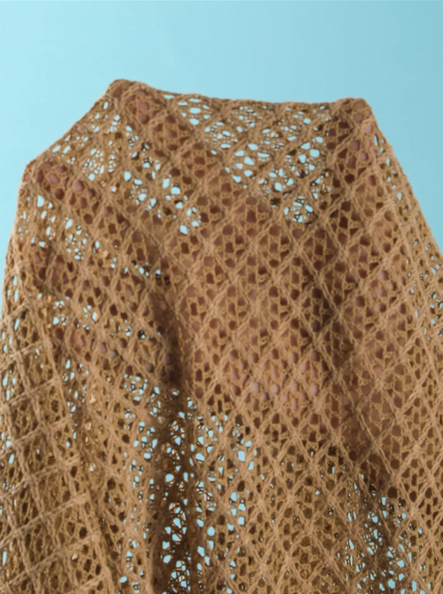 Close-up of dune openwork crochet-look fabric with diamond texture and sheer resort finish.