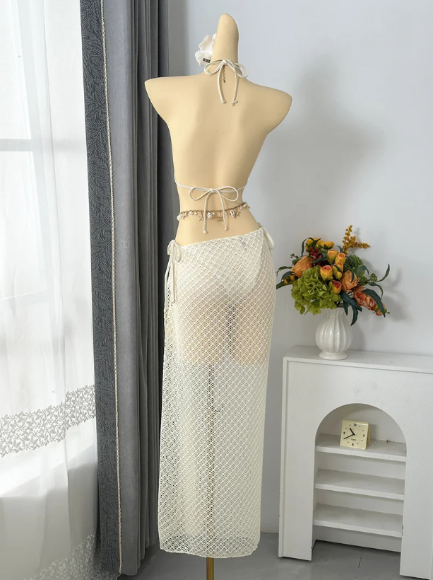 Back view of ivory openwork bikini and maxi sarong set with halter tie and back tie fastening.