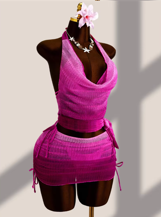 Angled view of the Orchid Estelle Set with bright pink draped halter cover-up, mini skirt overlay and side tie details.