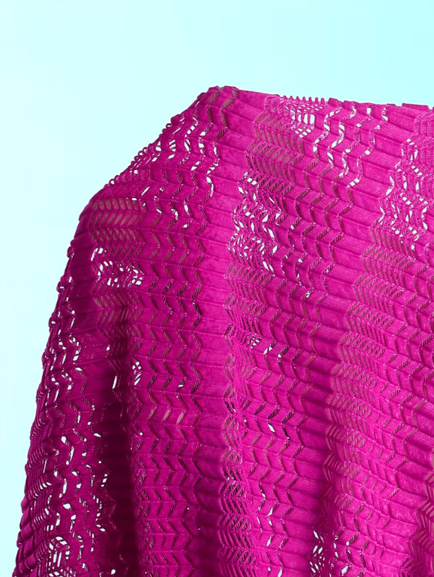 Close-up of the Orchid Estelle openwork fabric with bright pink textured crochet-look finish.