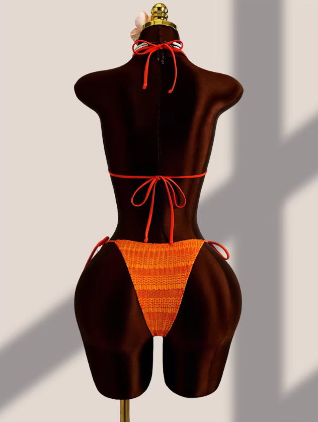 Back view of the CURATOR Collection Estelle Set in Saffron, showing the orange gradient bikini with halter tie top and tie-side bottoms.