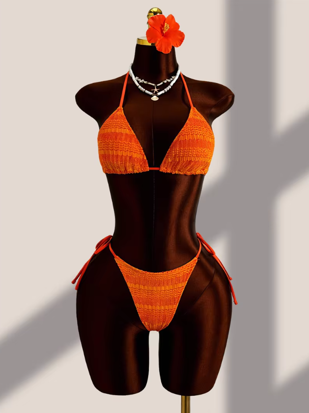 Close-up of the Saffron Estelle bikini with orange gradient textured triangle top and matching tie-side bottoms.