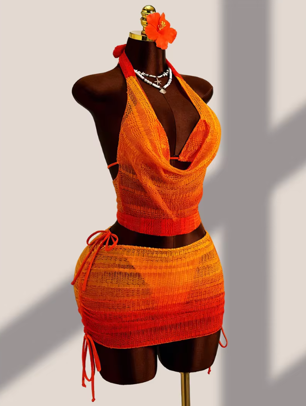 Angled view of the Saffron Estelle Set with orange gradient halter cover-up top, mini skirt overlay and side tie details.