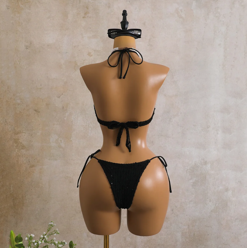 Back view of the black Milano Set bikini showing halter tie top, back tie closure and matching tie-side bottoms.