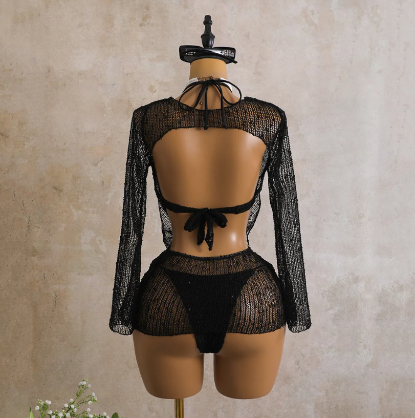 Back view of the black Milano Set cover-up showing open back detail, tie closure and sheer open-knit finish.