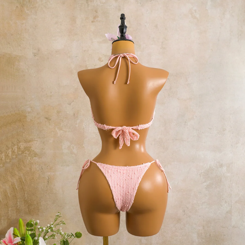 Back view of the camellia Milano Set bikini with halter tie top, back tie closure and matching textured tie-side bottoms.