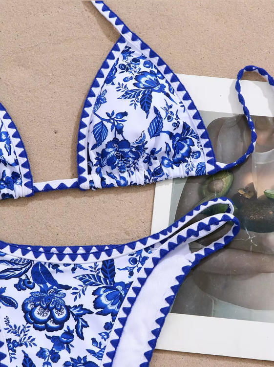 Close-up of blue porcelain-inspired floral bikini print with geometric border trim.