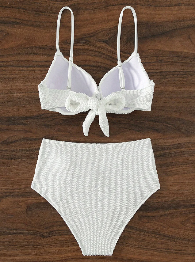 Flat lay back view of white textured bikini set showing adjustable straps, back tie top and high-waisted bottoms.