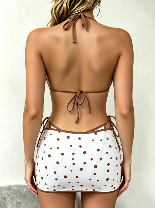 Back view of ivory polka dot bikini and matching mini skirt set with halter neck, back tie and side ties.