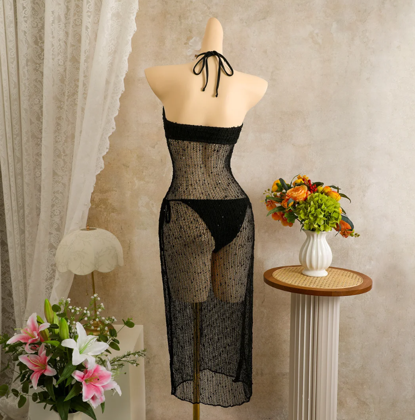 Back of black halter tie detail on sheer openwork resort dress.