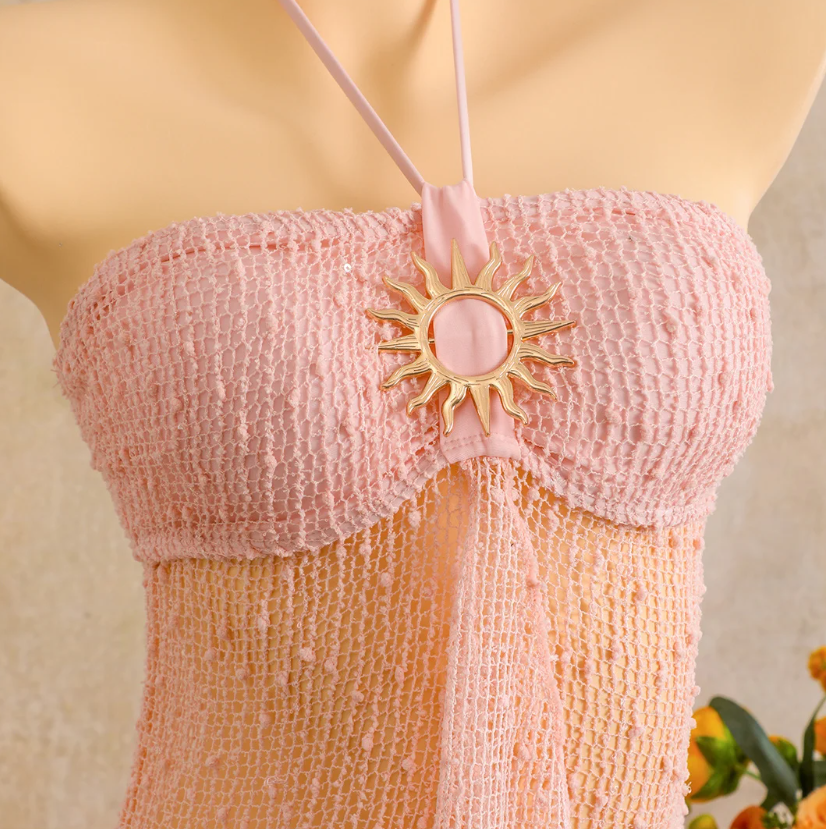 Close-up of camellia halter dress with textured bust panel and gold-tone sun centre hardware.