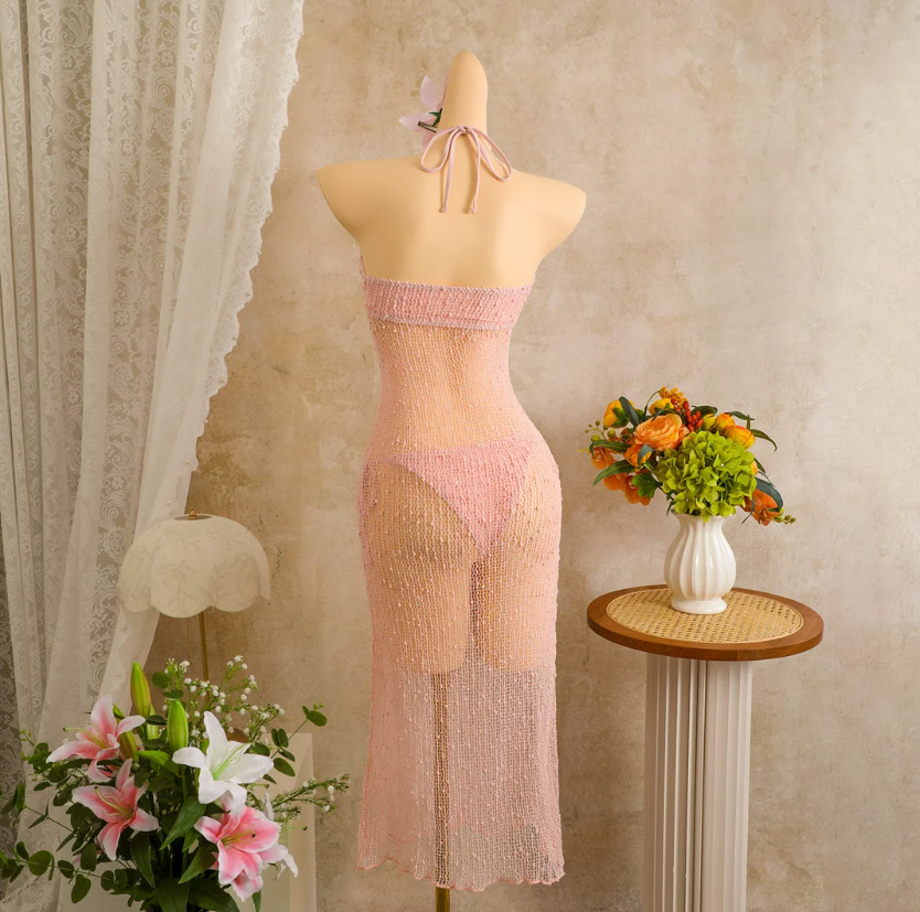 Back mannequin view of camellia sheer halter maxi dress with tie neck and openwork finish.