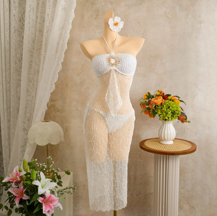 Ivory sheer openwork halter maxi dress set with gold-tone sun hardware displayed on mannequin.