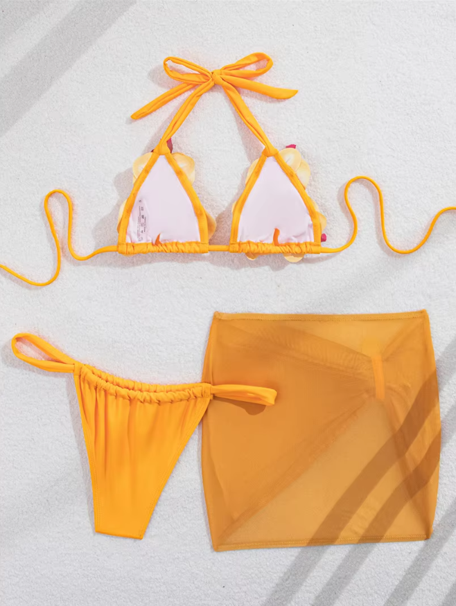 Back flat lay of orange orchid bikini and sheer mini skirt set showing lined cups, tie-side bottoms and mesh skirt.