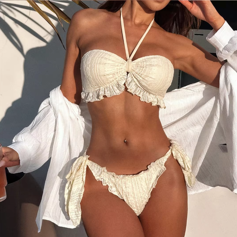 Front view of ivory textured bikini set with gathered bandeau top, lace-look trim and high-leg side-tie bottoms.