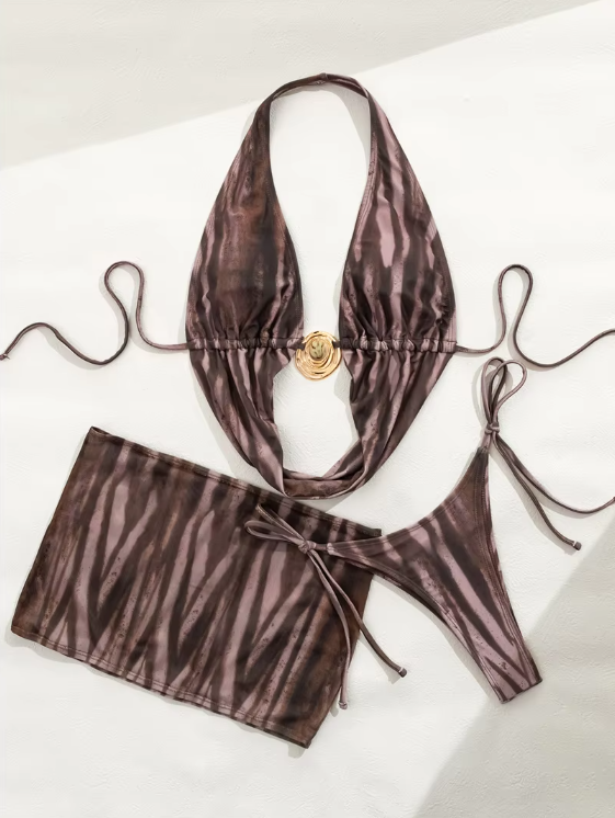 Flat lay of Lucia brown striped bikini and mini skirt set with plunging halter top, gold-tone shell hardware and tie-side bottoms.