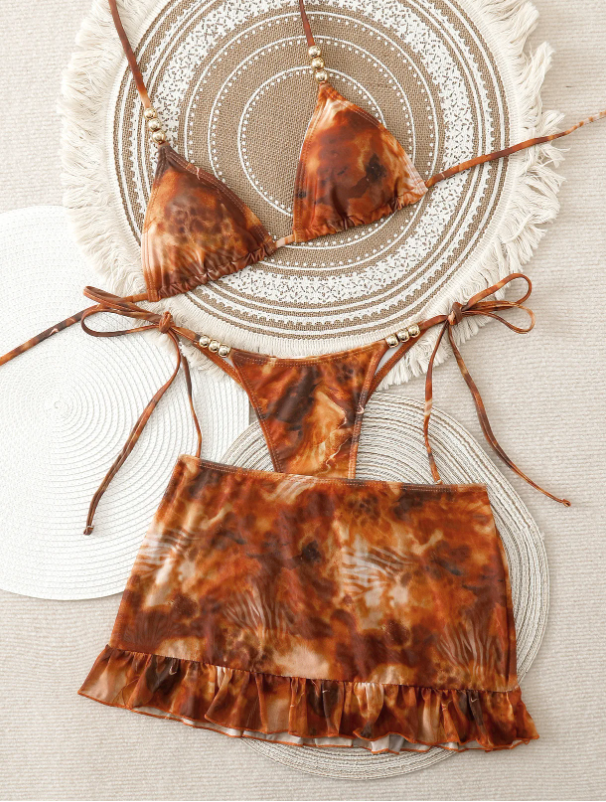 Amber marbled Marbella bikini and matching frill mini skirt set with triangle halter top and tie-side bottoms.