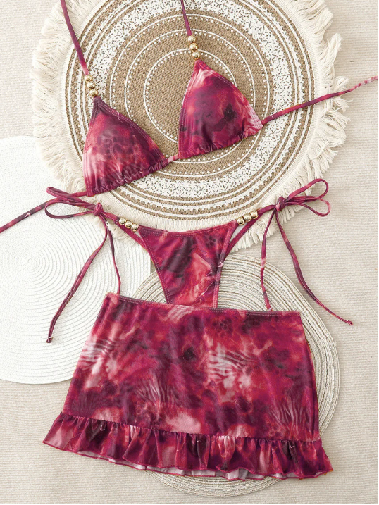 Mulberry marbled Marbella bikini and matching frill mini skirt set with triangle halter top and tie-side bottoms.