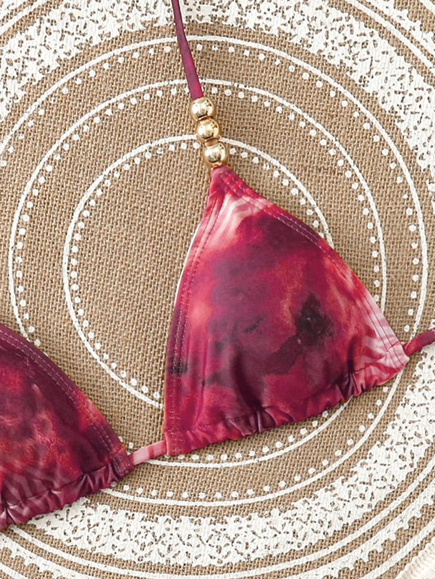Close-up of mulberry marbled triangle bikini top with halter tie, gathered cup and gold-tone bead detail.