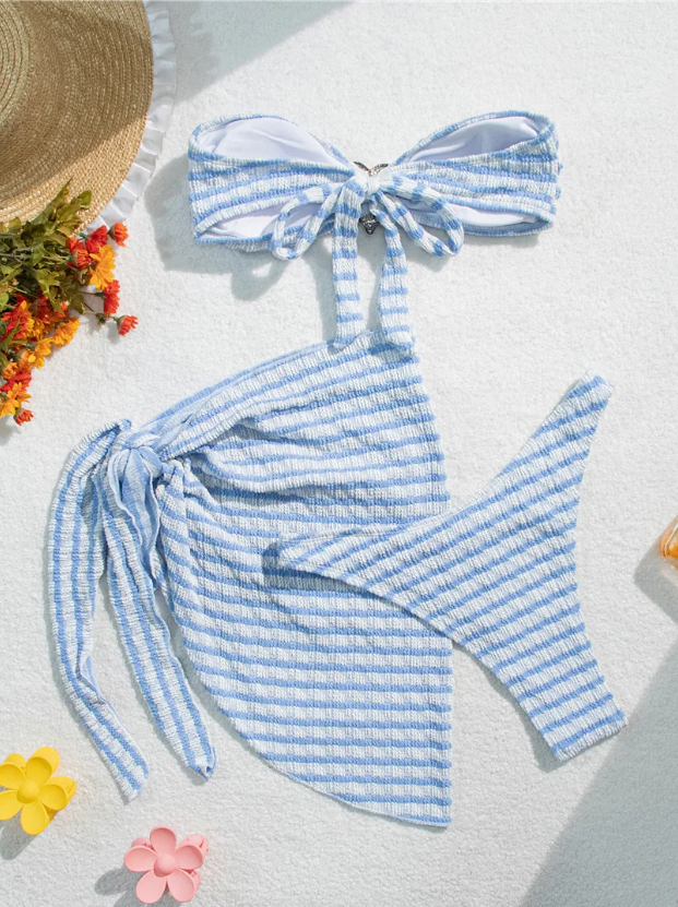 Reverse flat lay of Marina blue striped bikini and sarong set showing back of bandeau top, matching sarong and bikini bottoms.