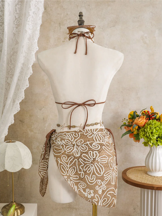 Back view of Cocoa Shell embroidered bikini and wrap sarong set with halter tie, back tie and asymmetric sarong drape.