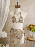 Cocoa Shell corded floral bikini and matching wrap sarong set displayed on mannequin with shell-inspired bead accents.