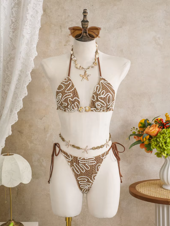 Cocoa Shell triangle bikini set with raised white corded embroidery, shell-inspired bead accents and tie-side bottoms.