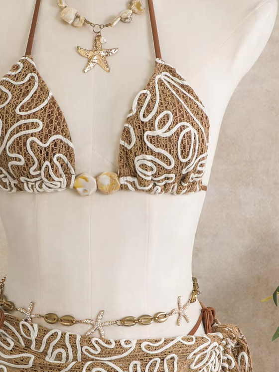 Close-up of Cocoa Shell corded floral bikini top with white raised embroidery and shell-inspired centre beads.
