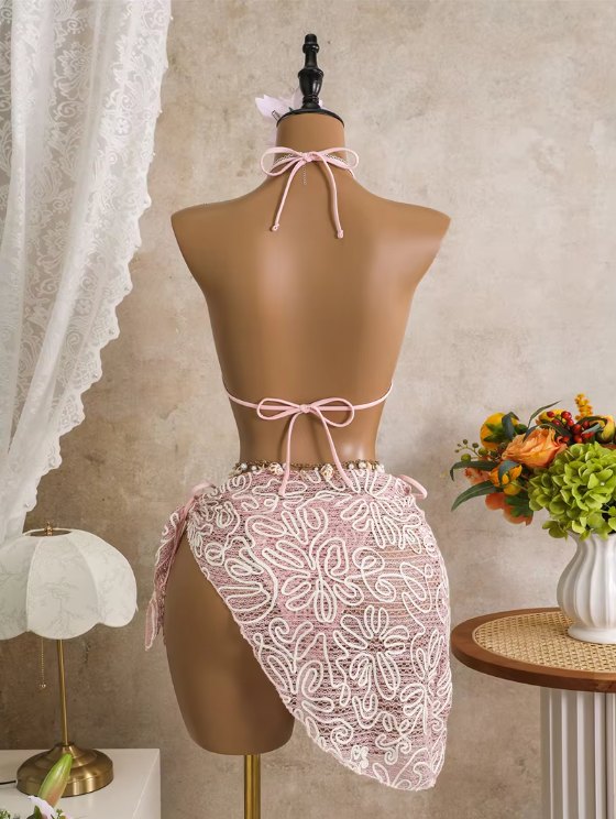 Back view of pink corded floral bikini and wrap sarong set with halter tie, back tie and asymmetric sarong drape.