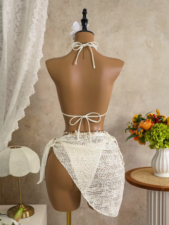 Back view of white corded floral bikini and wrap sarong set with halter tie, back tie and asymmetric sarong drape.