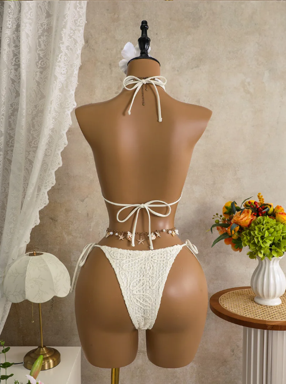 Back view of white embroidered bikini set with adjustable halter tie, back tie and cheeky tie-side bottoms.