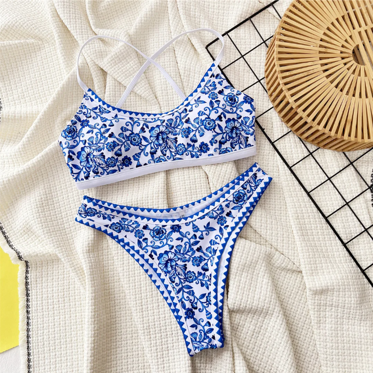 Close-up of blue porcelain-inspired floral bikini print with white contrast straps and trim.