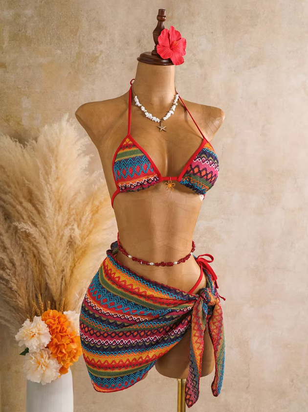 Angled front view of rainbow textured bikini and matching wrap sarong with red binding and side tie.