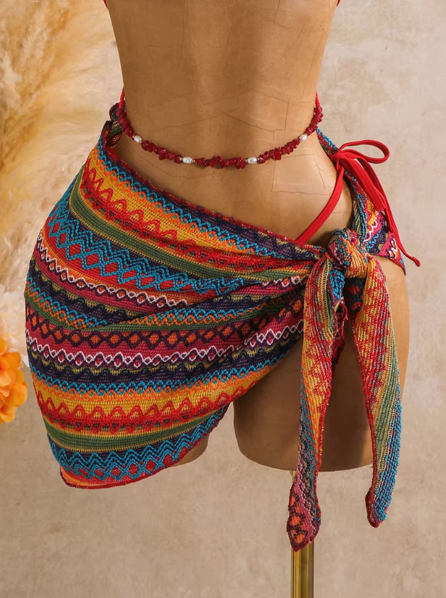 Close-up of rainbow textured wrap sarong with multicolour zigzag pattern and side tie detail.