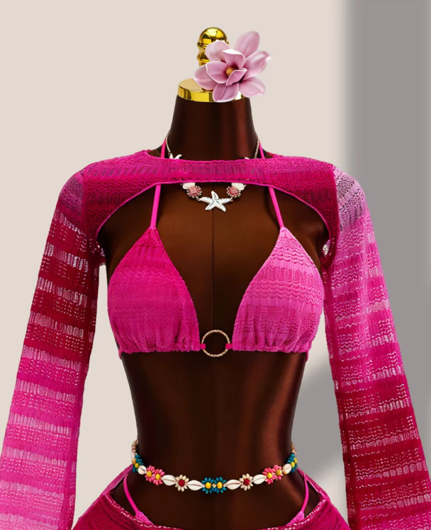 Close-up of fuschia ombré crochet-look bikini top with centre ring hardware and sheer long-sleeve bolero.