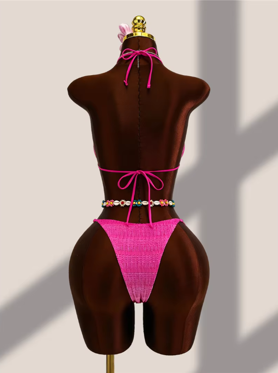 Back view of fuschia crochet-look bikini set with halter tie, back tie and minimal high-leg bottoms.