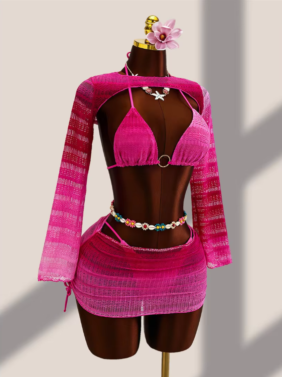 Angled front view of fuschia ombré bikini and sheer mini skirt set with long-sleeve crochet-look bolero.